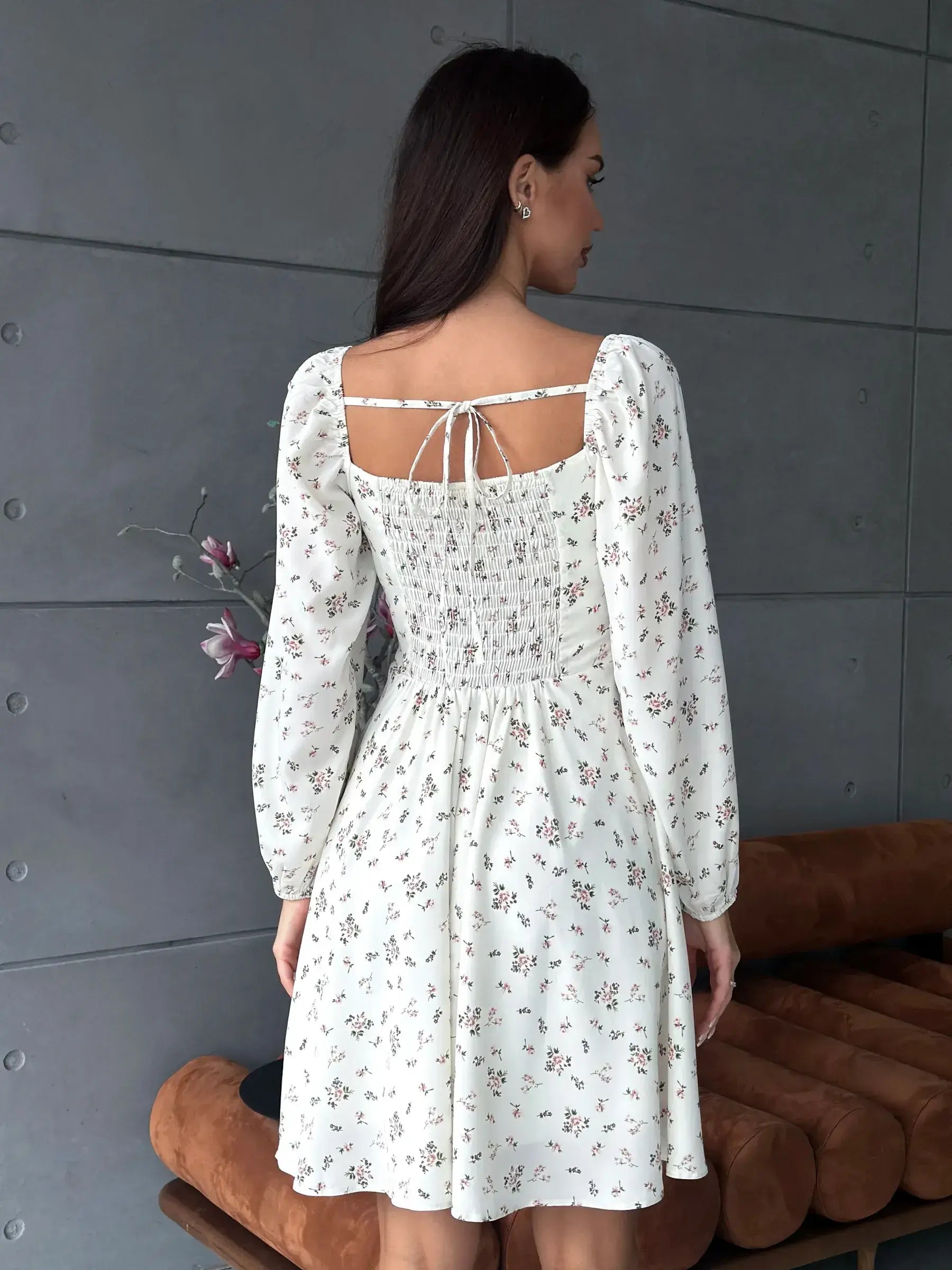 Back view of the Blossom Grace white dress featuring floral print and puff sleeves, perfect for summer celebrations.