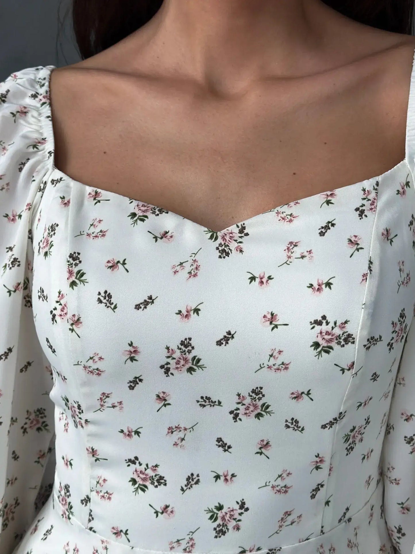 Close-up of the Blossom Grace white dress with a floral print and sweetheart neckline, perfect for summer celebrations.