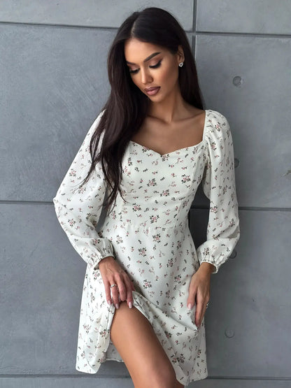 Elegant white floral dress with sweetheart neckline and long sleeves, perfect for summer celebrations and stylish events.