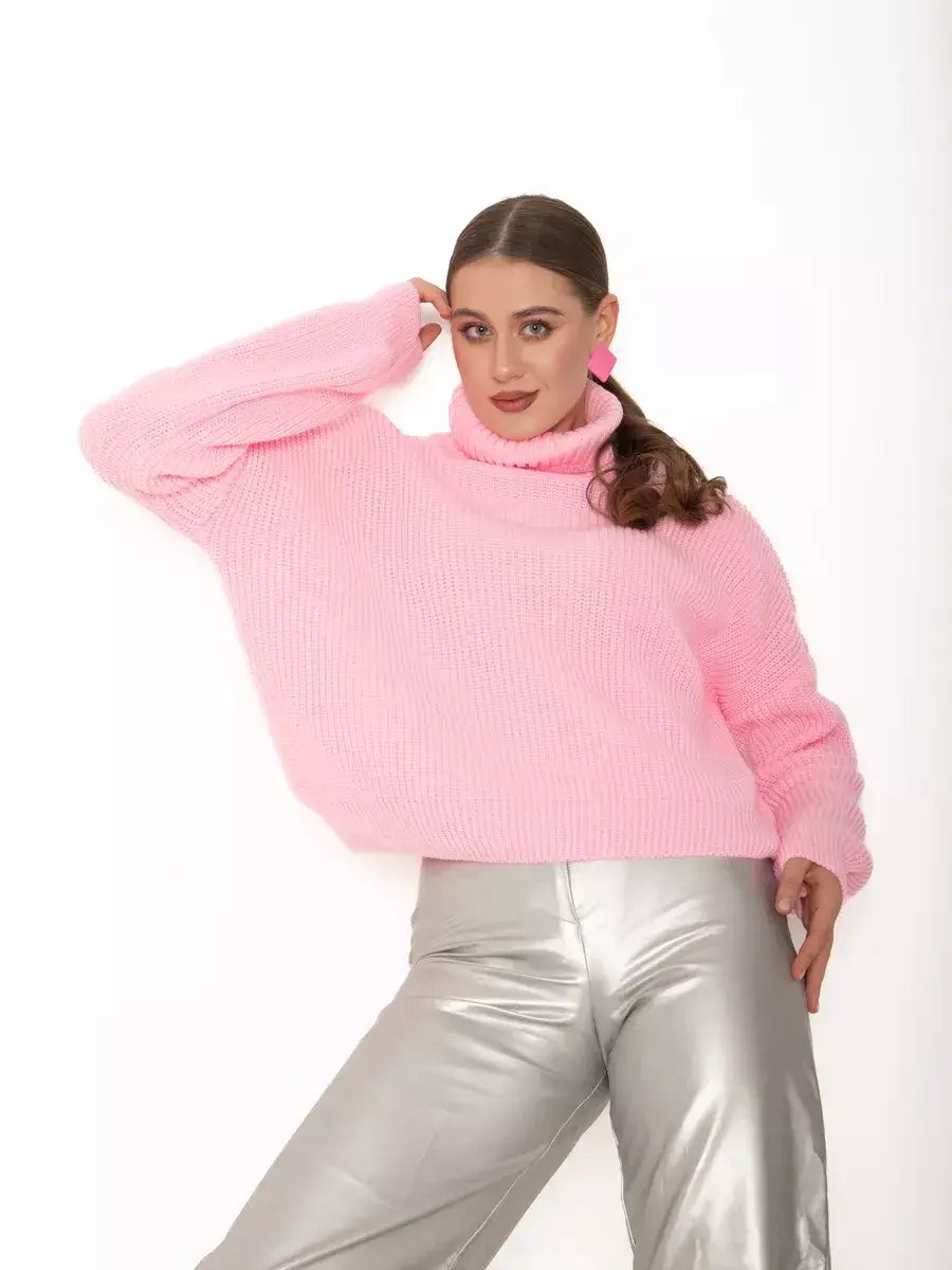 Model wearing Blossom Pullover by Lauven, an oversized light pink knit sweater with a high neck.