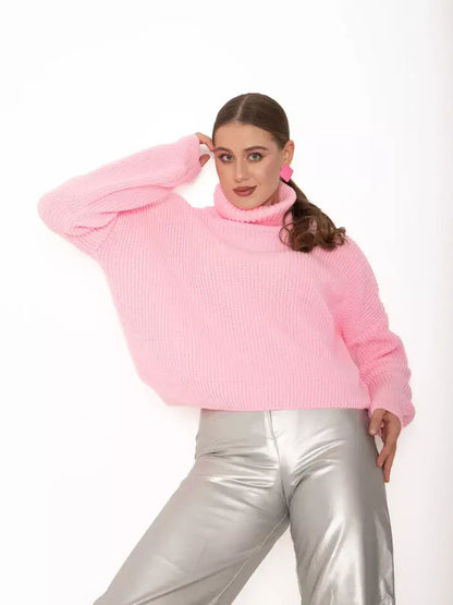 Model wearing Blossom Pullover by Lauven, an oversized light pink knit sweater with a high neck.