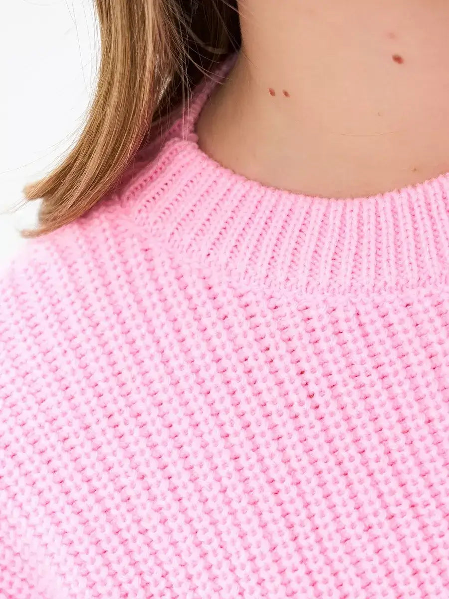 Close-up of the neck area of the Blossom Sweater by Lauven, showcasing its soft pink knit texture.