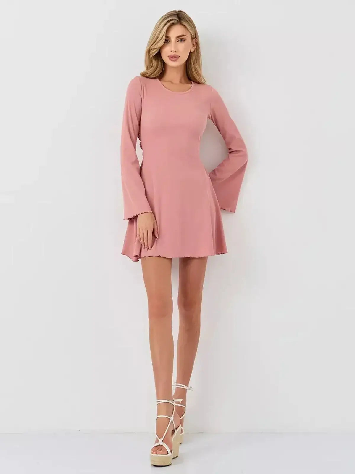 Blush Aura mini dress by Lauven, featuring a soft pink color, A-line silhouette, and flared long sleeves.