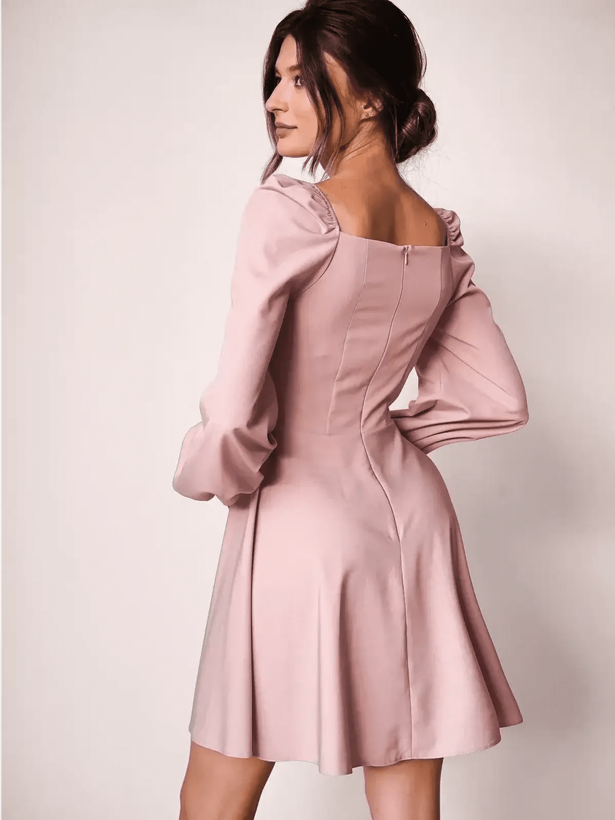 Back view of the Blush Aura mini dress featuring a fitted bodice, flared skirt, and elegant puff sleeves.