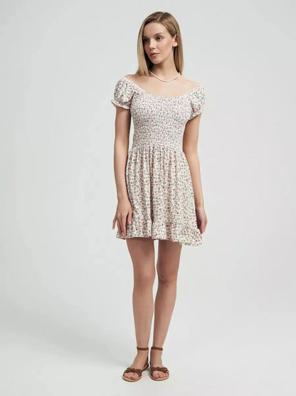 Romantic Blush Blossom dress with pink floral prints and smocked bodice, ideal for summer outings and garden parties.