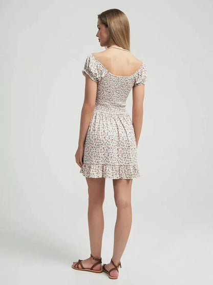 Back view of a woman in a floral summer dress with a ruffled hem, perfect for romantic outings.