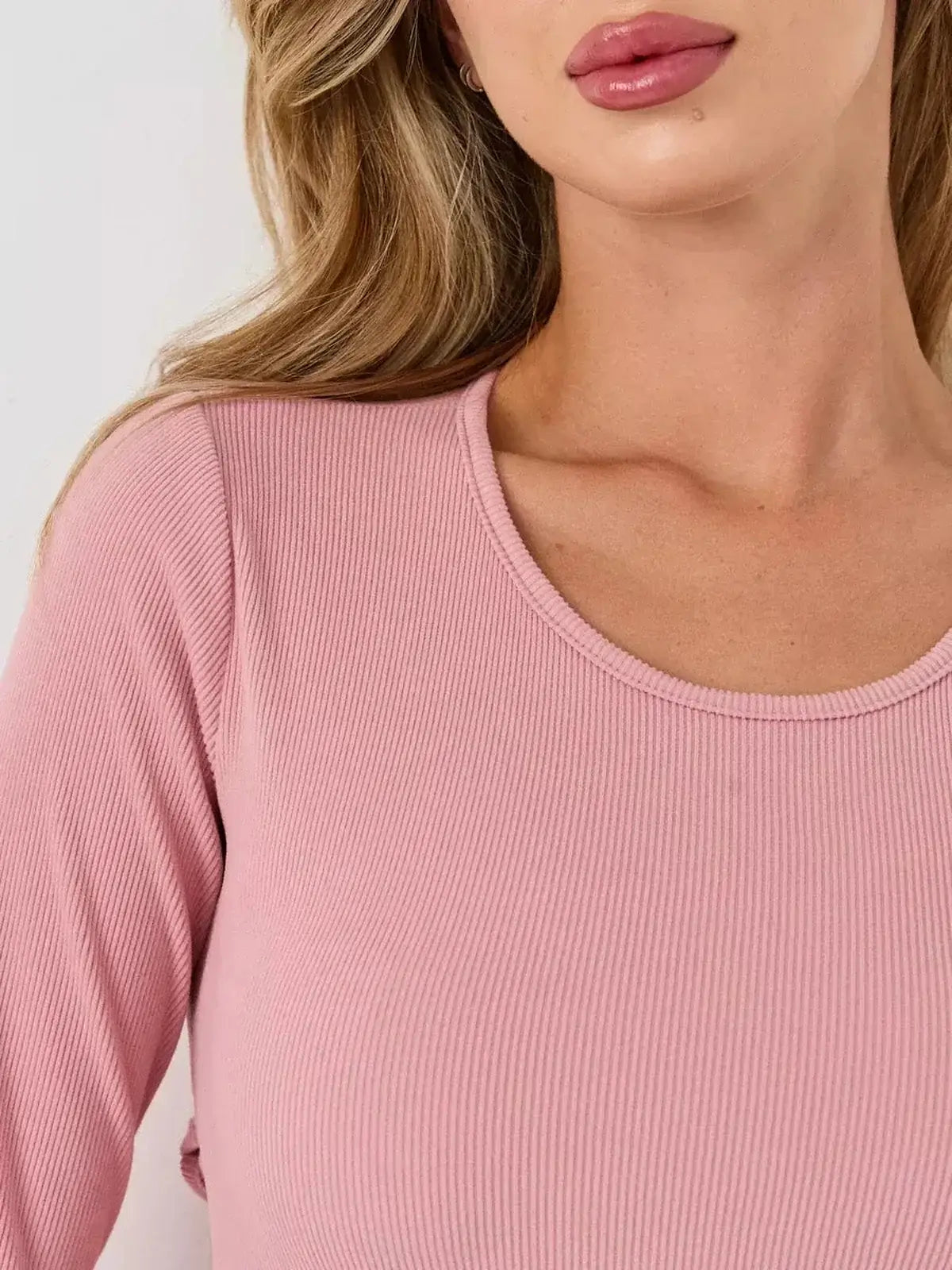 Close-up of the scoop neckline and textured fabric of the Blush Flare mini dress by Lauven, showcasing soft elegance.