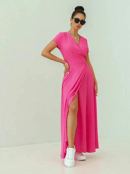 Blush Radiance Maxi Dress in vibrant pink polka dot print with V-neckline and leg slit for summer elegance.