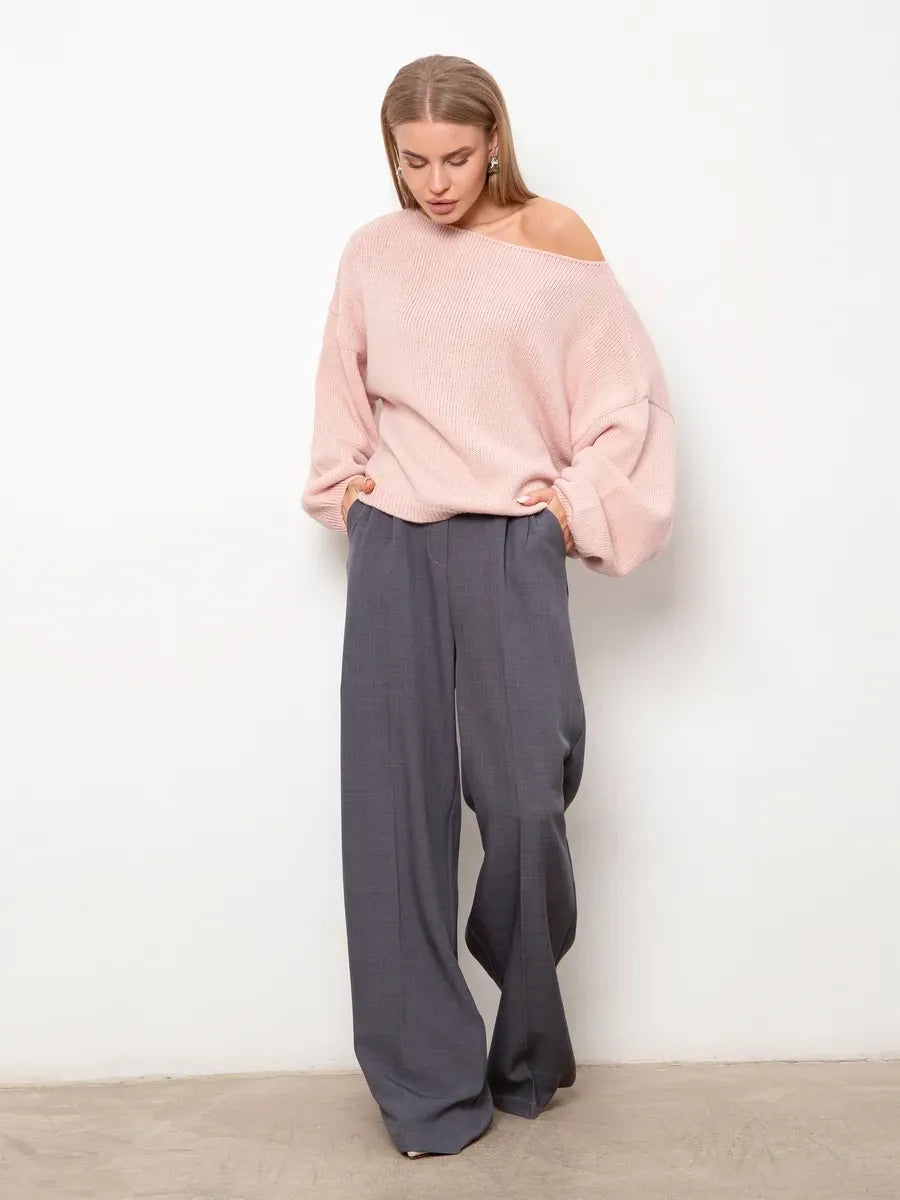 Model wearing a Blush Sweater by Lauven with oversized fit and boat neck, paired with wide-leg trousers.