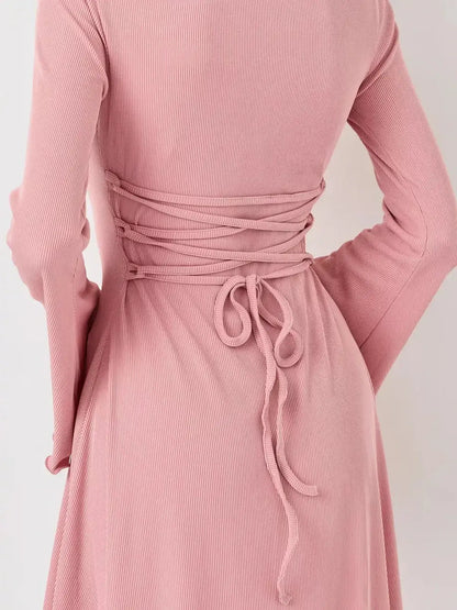 Detail of the Blush Whisper dress by Lauven, showcasing the beautiful back lacing fabric design in soft pink.
