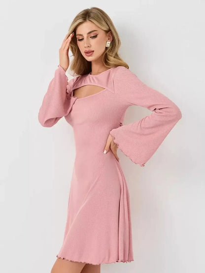 Model wearing the Blush Whisper by Lauven, a pink feminine dress with flared sleeves and U-neckline.