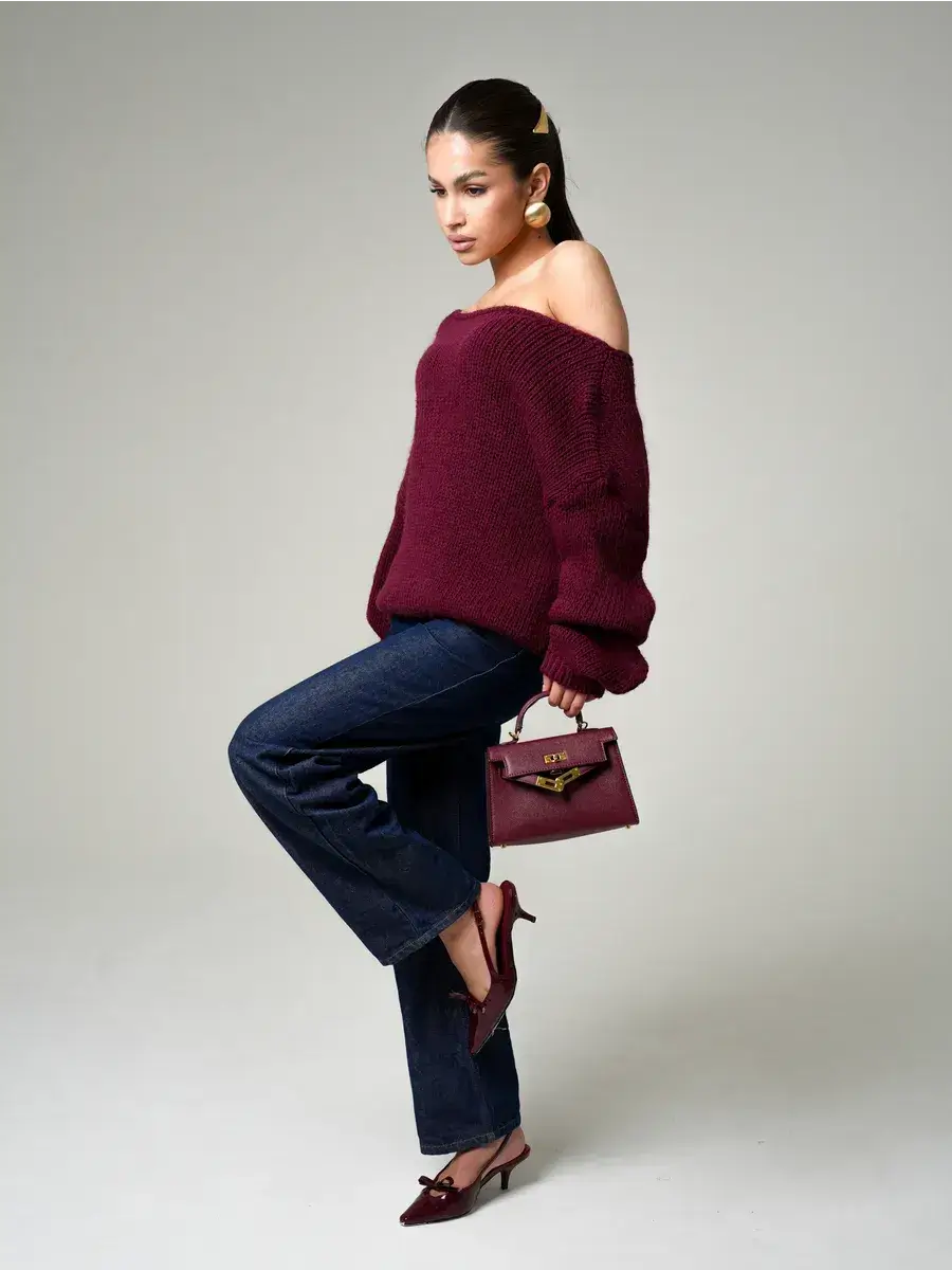 Bordeaux Sweater by Lauven — oversized off-shoulder knit in deep wine showcased with chic blue jeans.