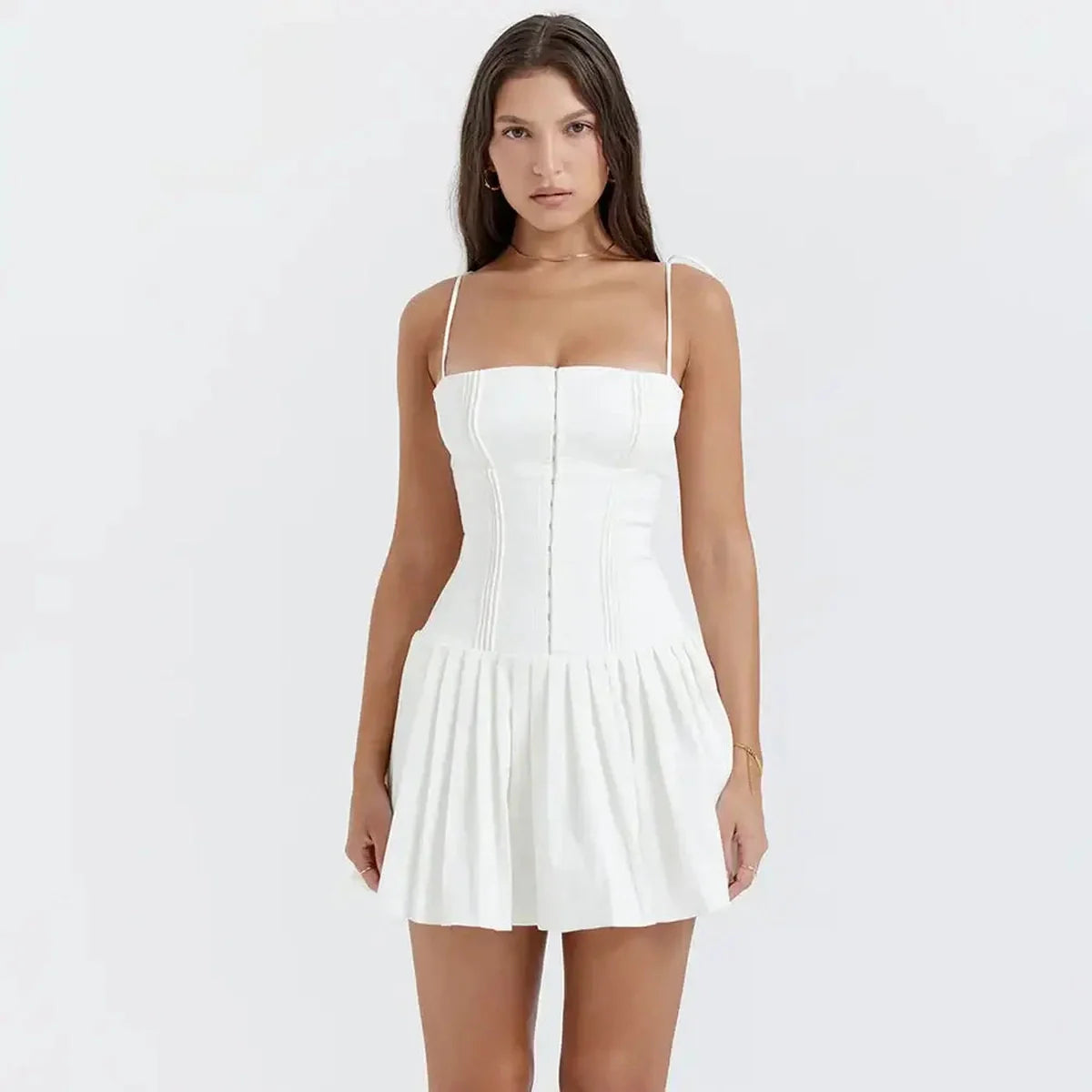 Chic white mini dress featuring flirty pleats, perfect for summer events and wedding guest outfits.