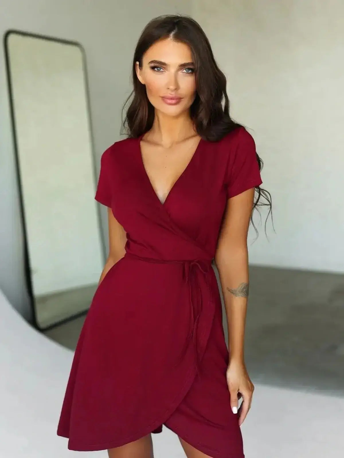 Burgundy wrap mini dress with short sleeves, perfect for summer casual or semi-formal events.