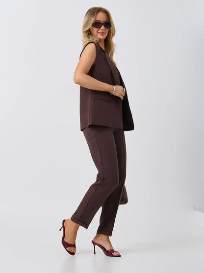 Model showcasing the Lauven Cacao Suit Set featuring a sleeveless chocolate vest and high-waist pants.