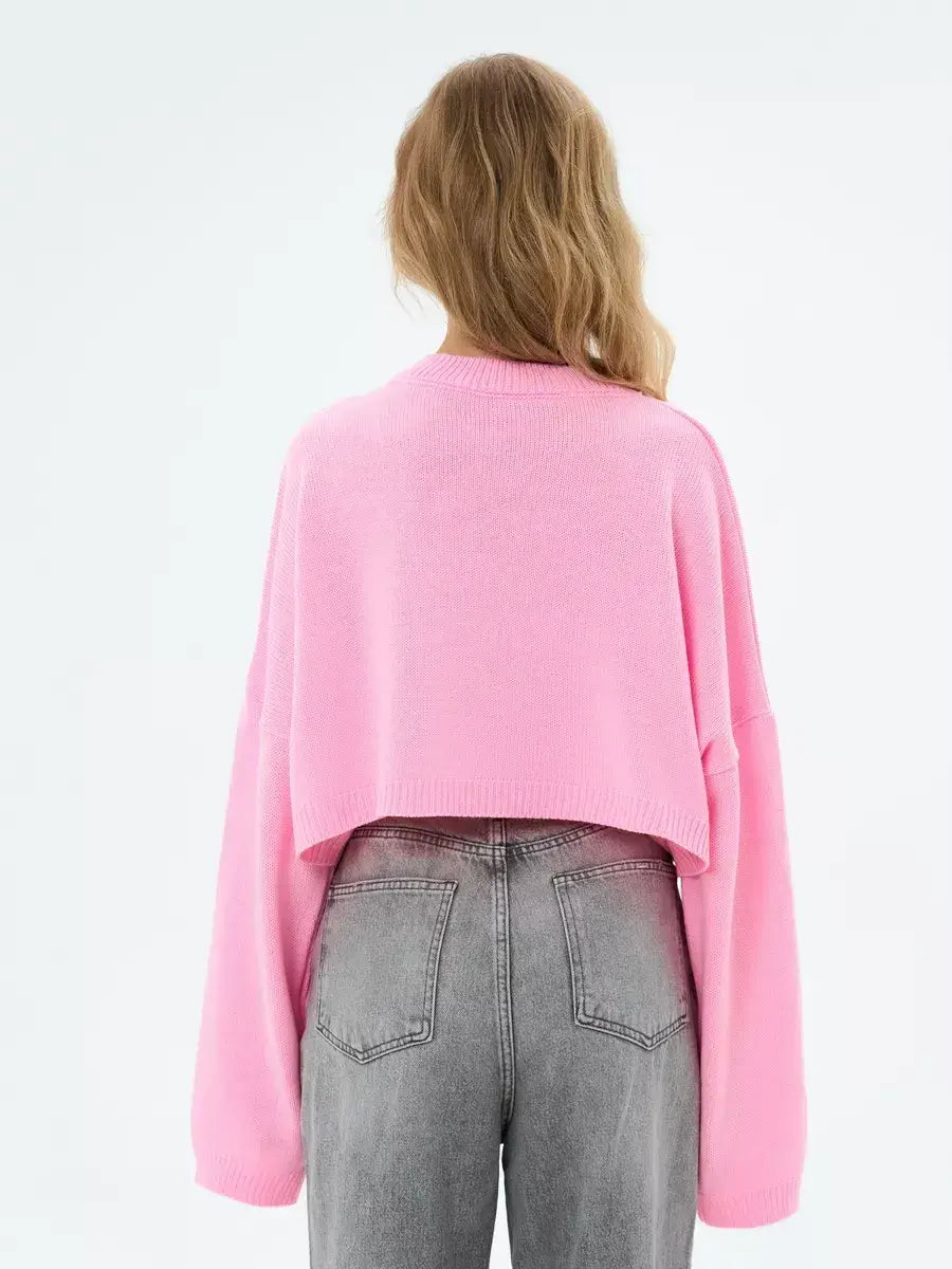 Back view of a model wearing a cropped oversized Candy Sweater in soft pink by Lauven.