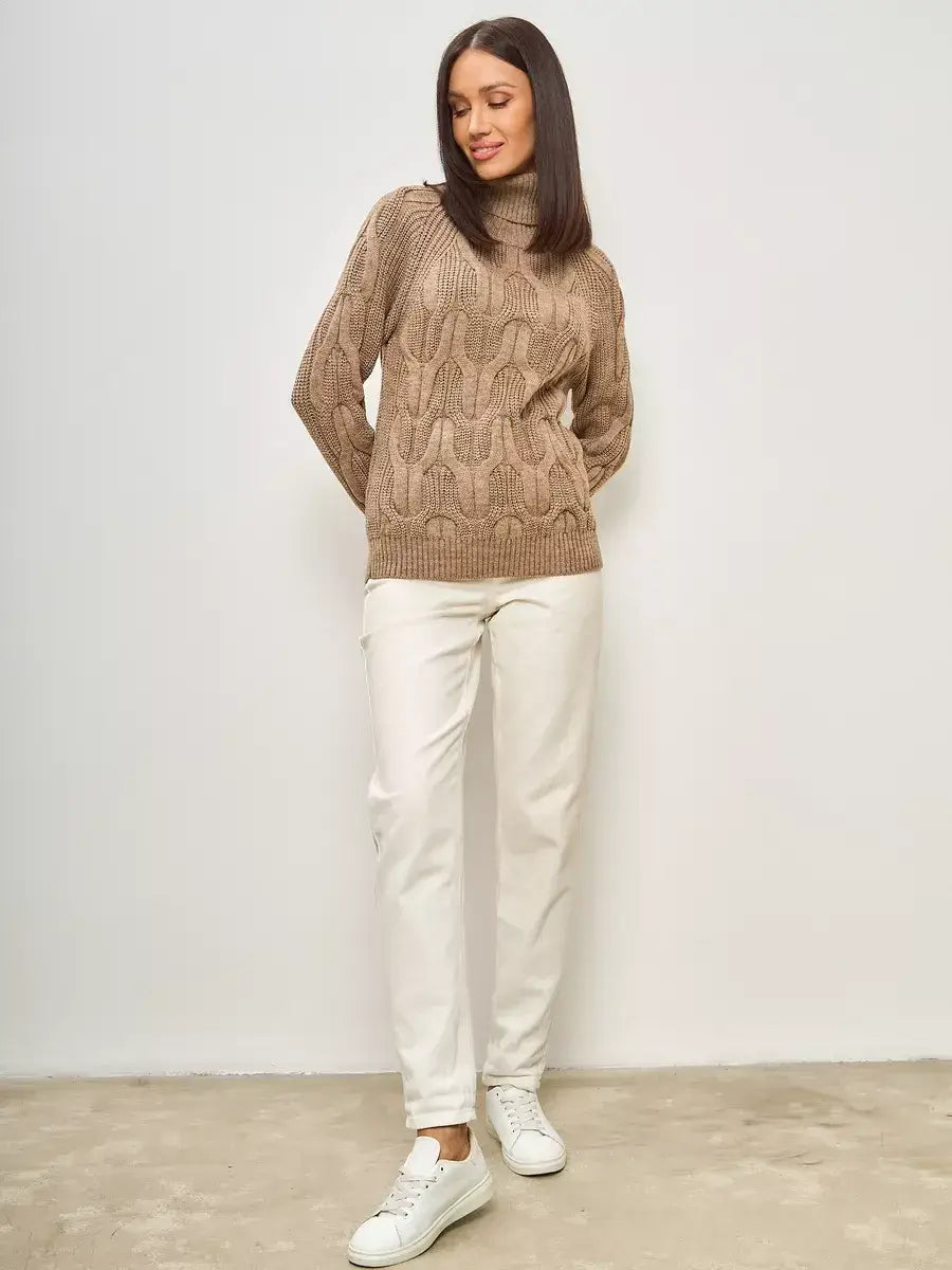 Cappuccino Knitwear by Lauven, oversized wool-blend turtleneck sweater worn with white pants.
