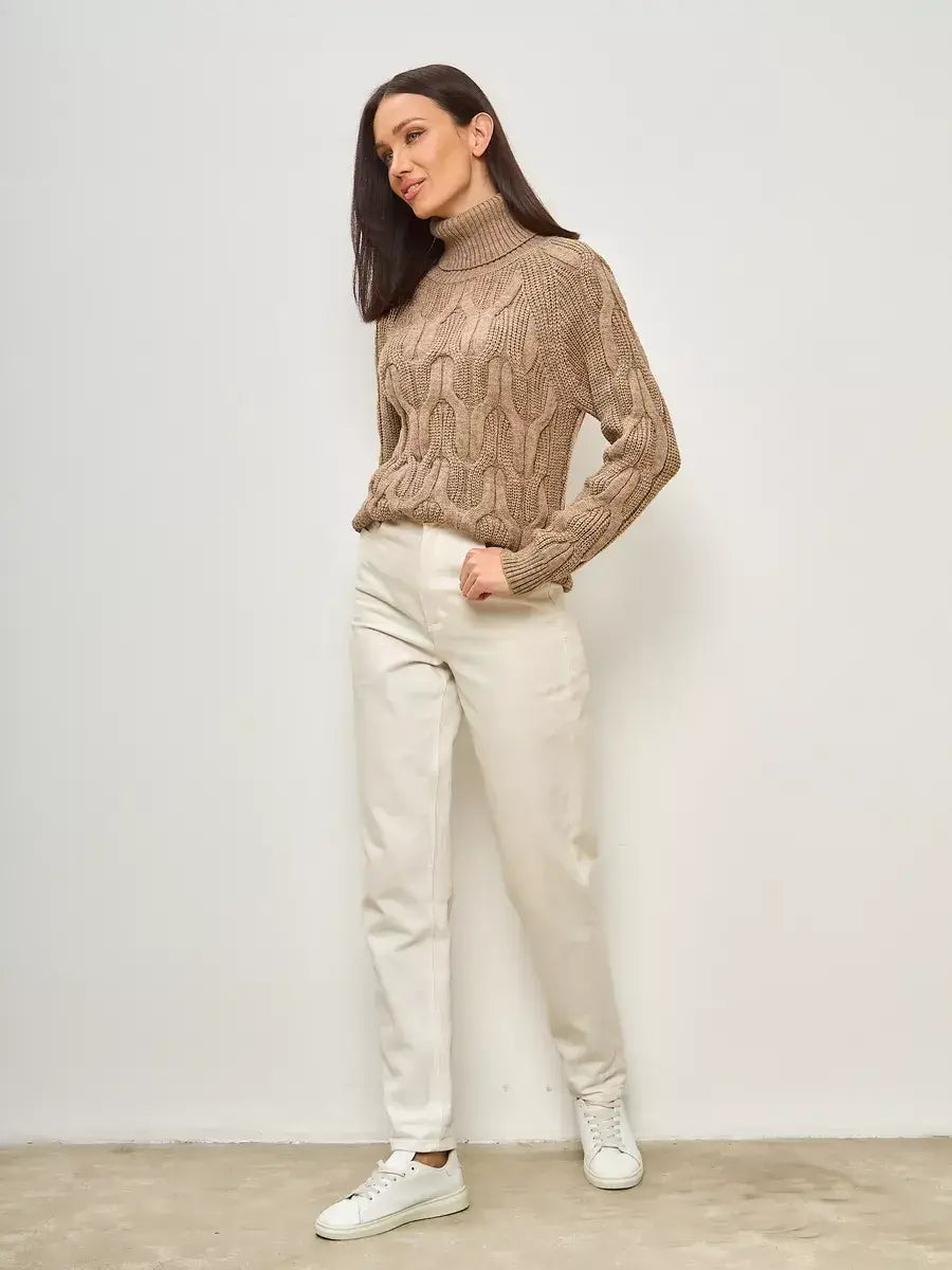 Cappuccino Knitwear by Lauven, oversized wool-blend turtleneck sweater styled with white trousers.