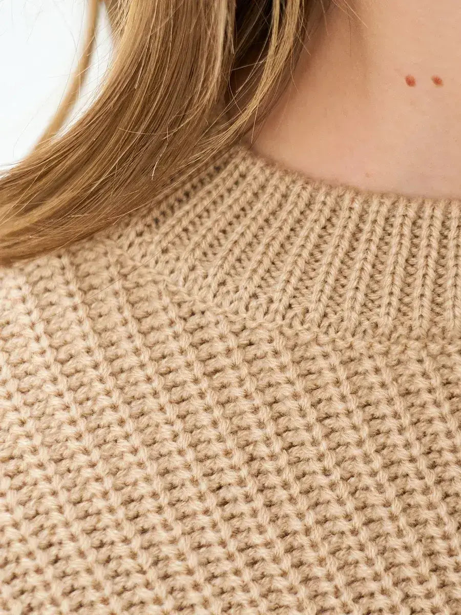 Close-up of the neck and knit texture of the Lauven Cappuccino Sweater in warm beige.