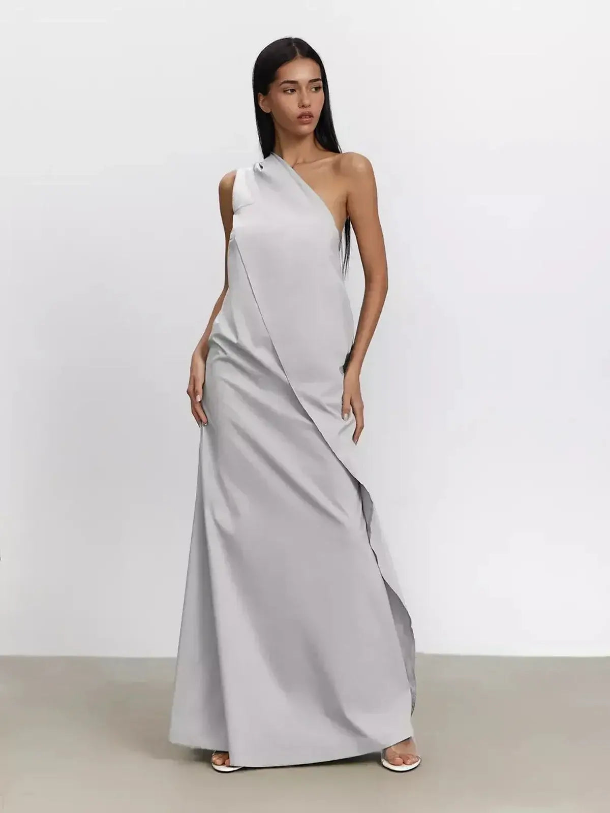 Elegant one-shoulder Cascade Maxi Dress in breathable cotton with a flowing A-line silhouette.