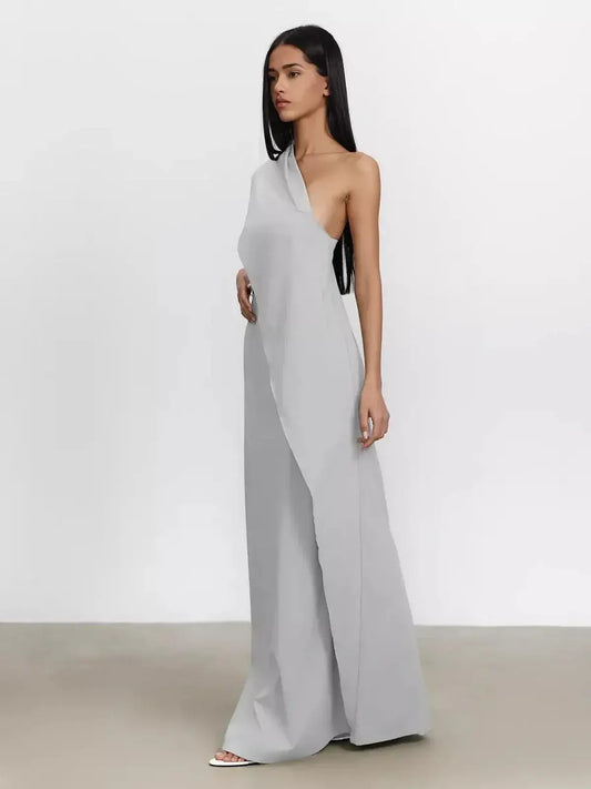 Cascade Maxi Dress in soft grey with a one-shoulder silhouette, showcasing its elegant flowing design.