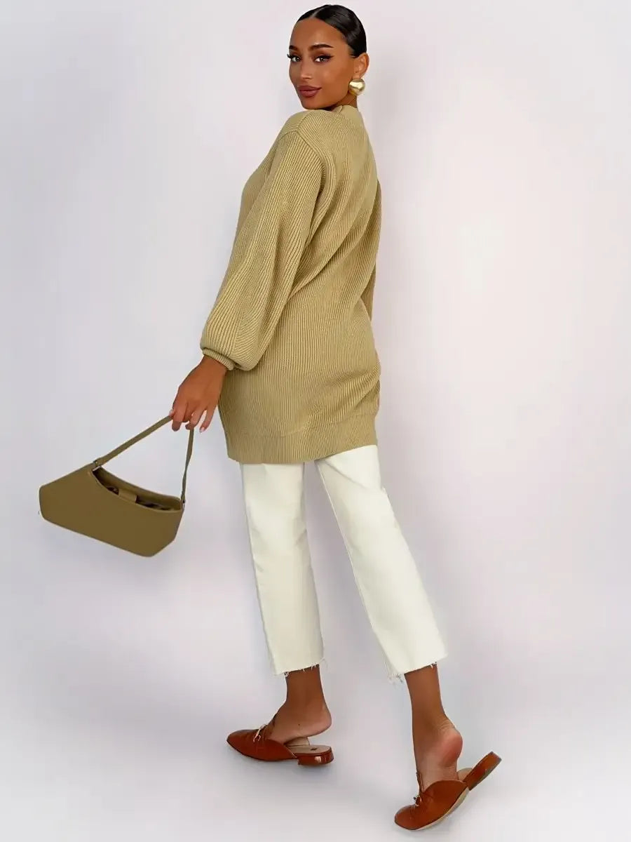 Woman wearing Celeste Cardigan by Lauven in warm beige, styled with white pants and brown mules.