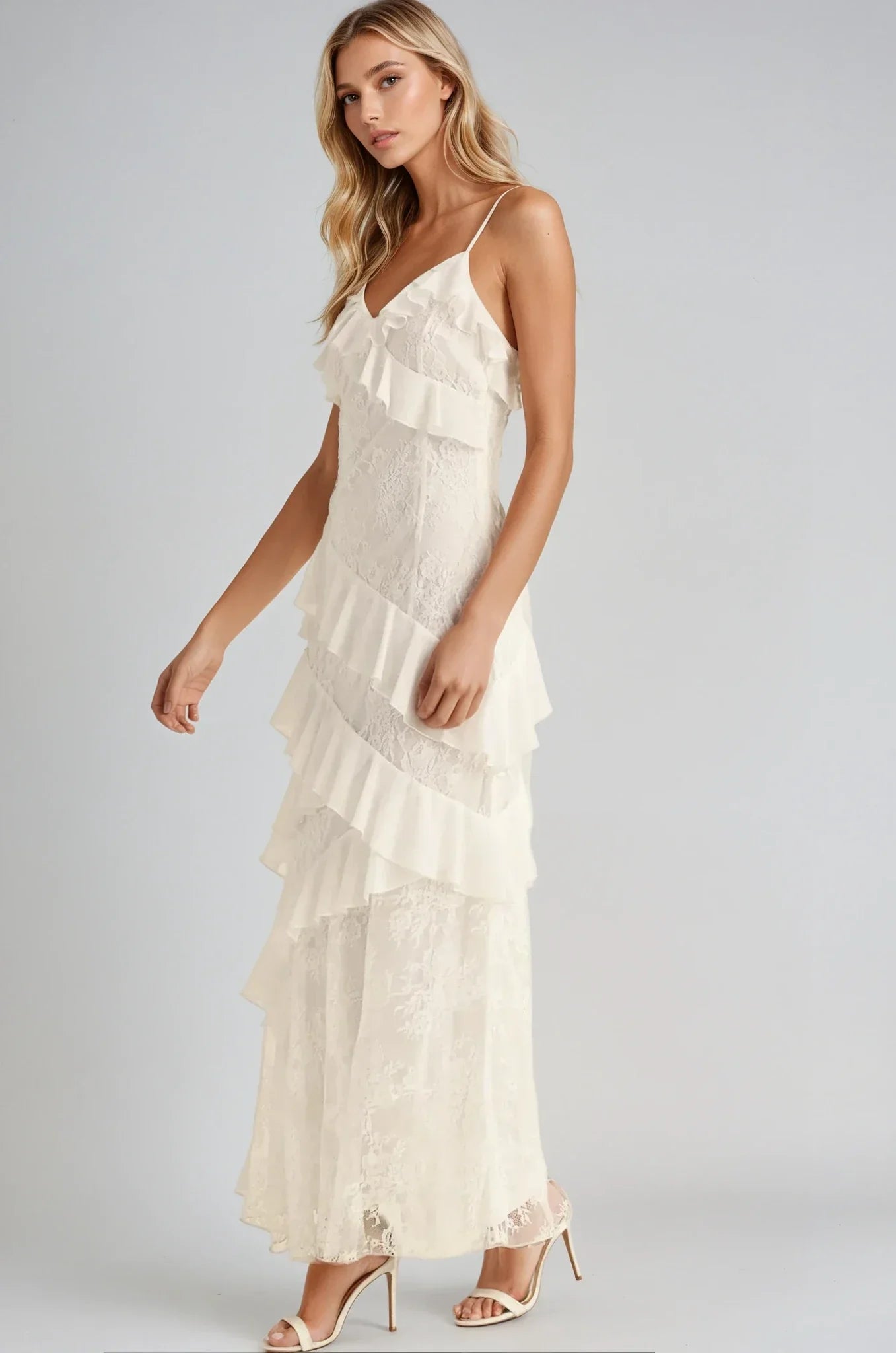 Elegant off-white maxi dress with cascading ruffles, perfect for weddings and special occasions.