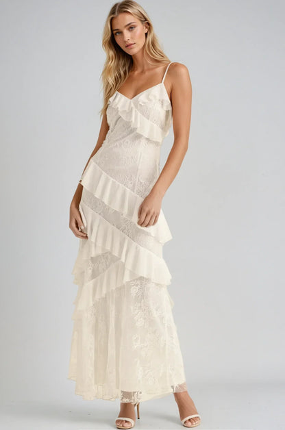 Elegant off-white maxi dress with cascading ruffles and lace inserts, perfect for weddings and special occasions.