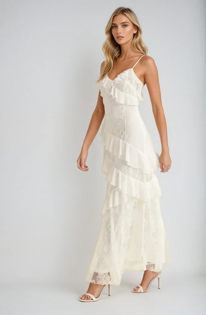 Elegant off-white maxi dress with cascading ruffles and lace inserts, perfect for weddings and formal occasions.