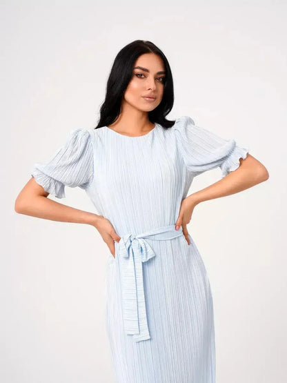 Celeste Flow Maxi Dress in light blue, featuring pleated fabric, puff sleeves, and a self-tie waistbelt, perfect for summer events.