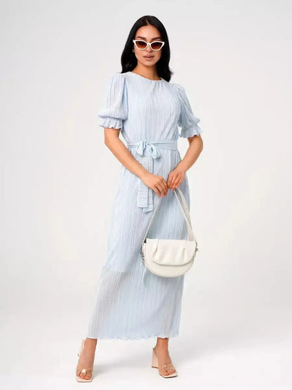 Celeste Flow Maxi Dress in light blue with pleats and waist tie, perfect for summer weddings and formal occasions.