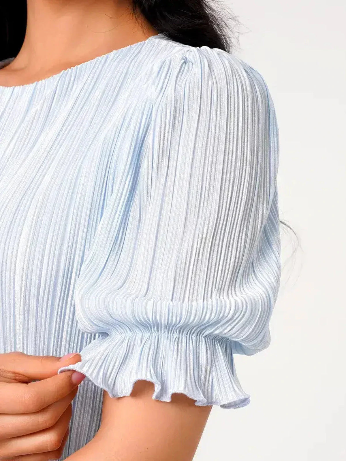 Close-up of puff sleeve on Celeste Flow Maxi Dress, featuring light blue pleated fabric and delicate ruffle detail.