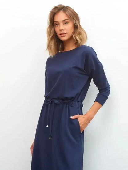 Woman wearing the elegant navy Celeste Maxi Dress with a relaxed fit, perfect for weddings and formal occasions.