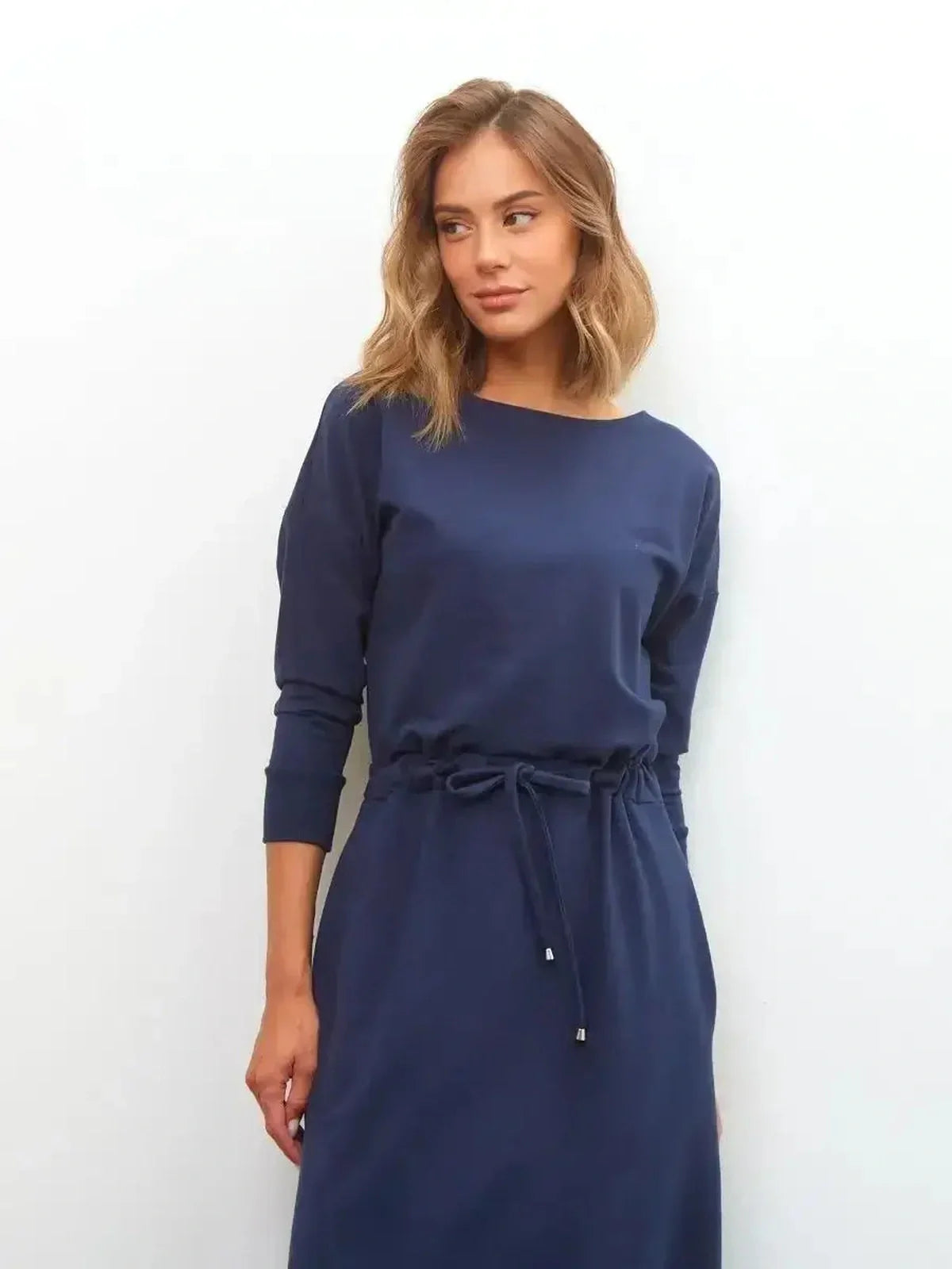Celeste Maxi Dress in elegant navy with long sleeves, featuring a relaxed fit and drawstring waist for versatile style.