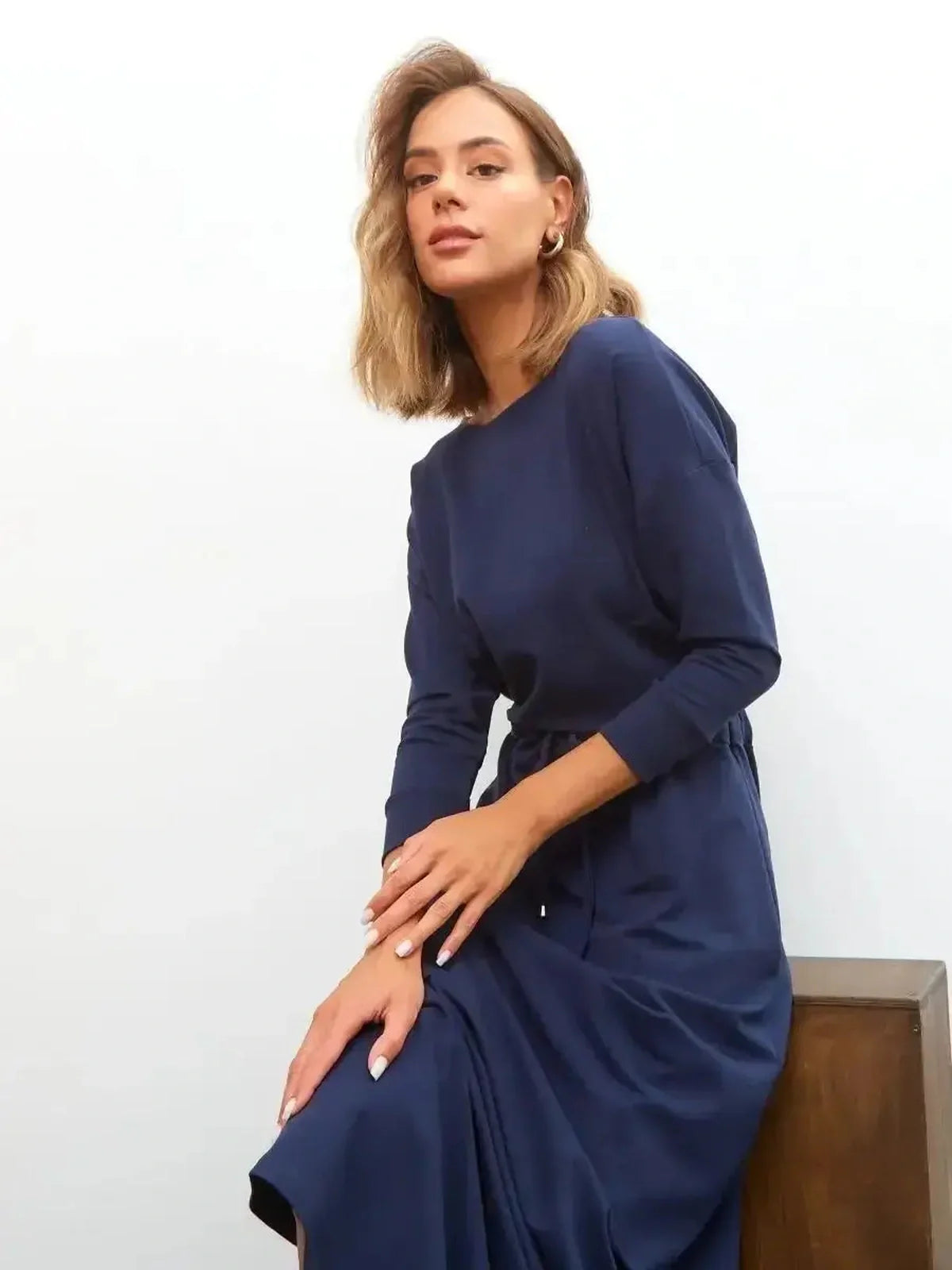 Model showcasing the elegant Celeste Maxi Dress in navy, perfect for weddings and formal occasions.