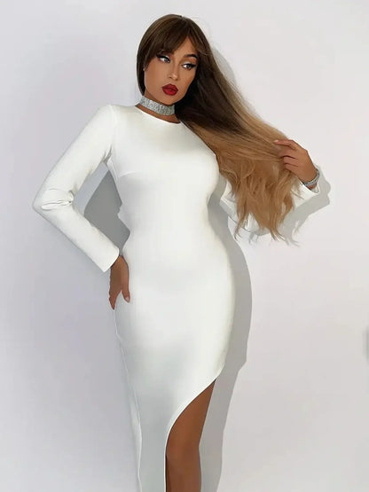 Celeste Maxi Dress in creamy-white with asymmetric hemline, showcasing elegant silhouette and chic accessories.