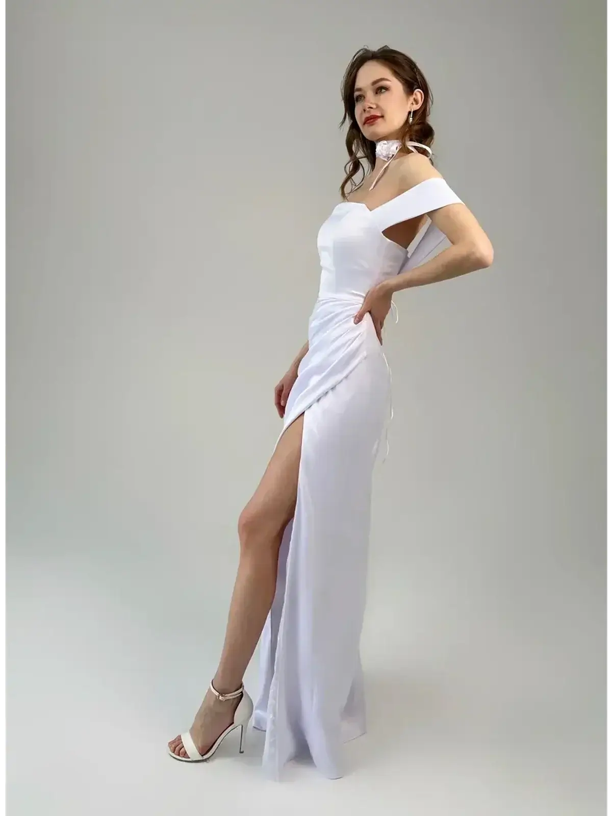 Celeste Maxi Dress in white, off-shoulder with a thigh-high slit and corset-inspired lace-up back, showcasing elegant draping.