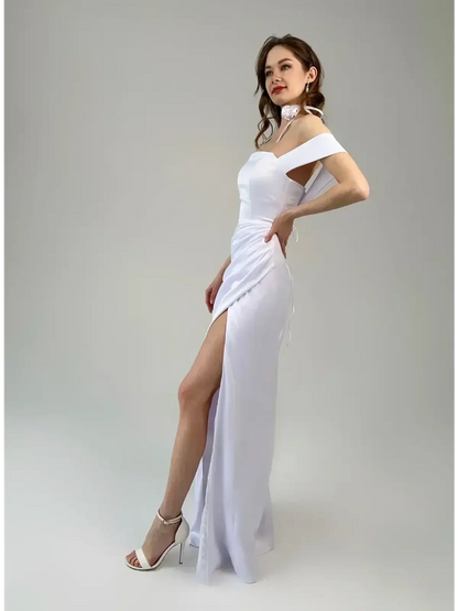Celeste Maxi Dress in white, off-shoulder with a thigh-high slit and corset-inspired lace-up back, showcasing elegant draping.