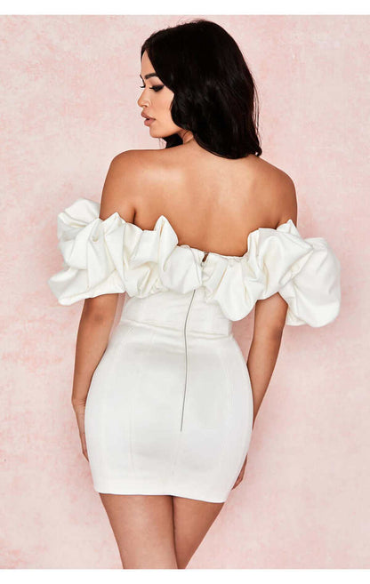 Back view of a women’s off-shoulder white mini dress with ruffles, perfect for weddings or evening events.