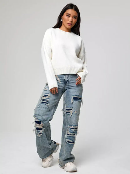 Model wearing Celeste Pullover by Lauven, an oversized cropped women's sweater, paired with distressed jeans.