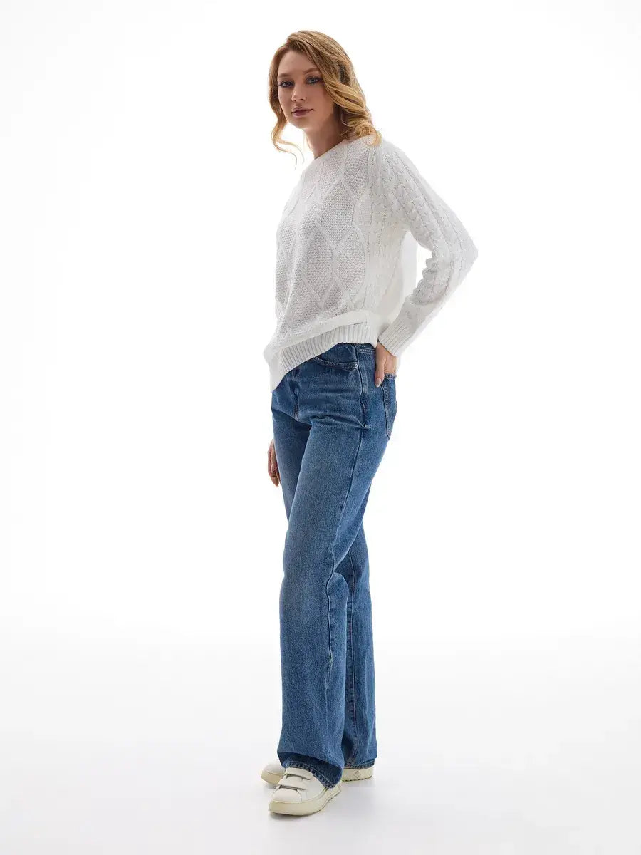 Celeste Sweater by Lauven, elegant white knitwear with patterned sleeves, styled with blue jeans.