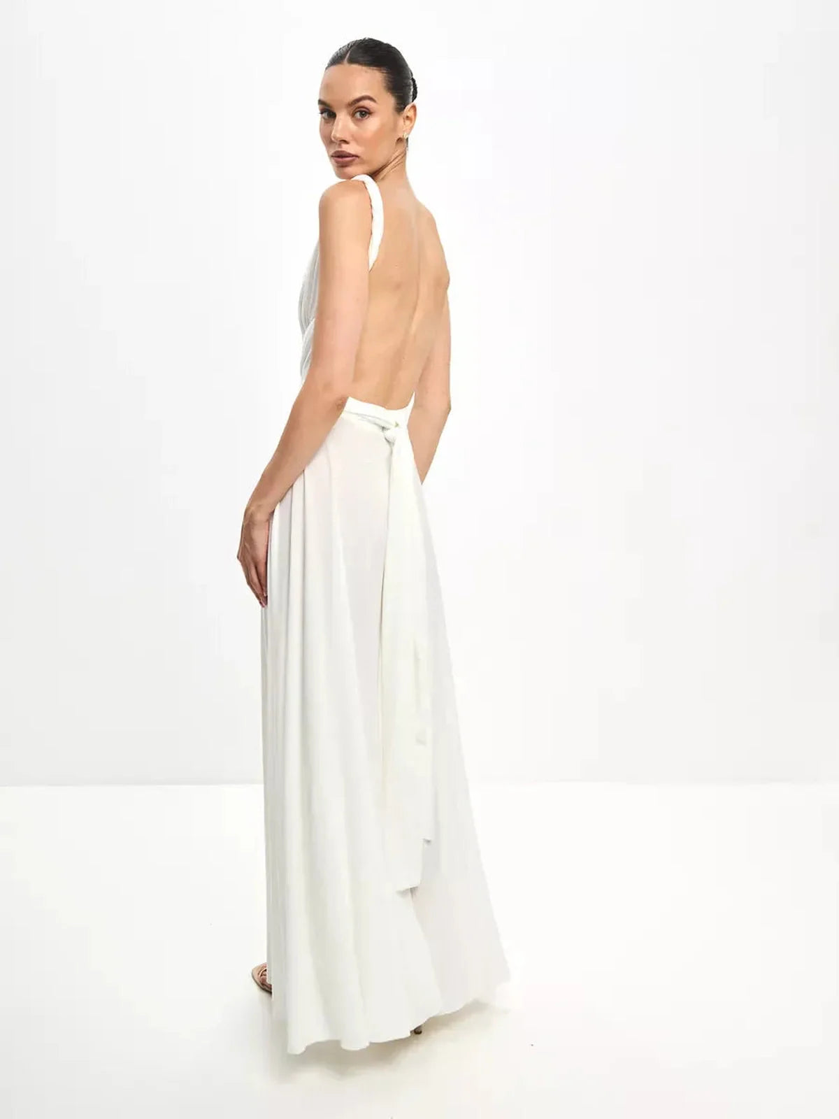 Back view of the Celeste Wrap Maxi Dress showcasing its elegant draped bodice and convertible tie detail.