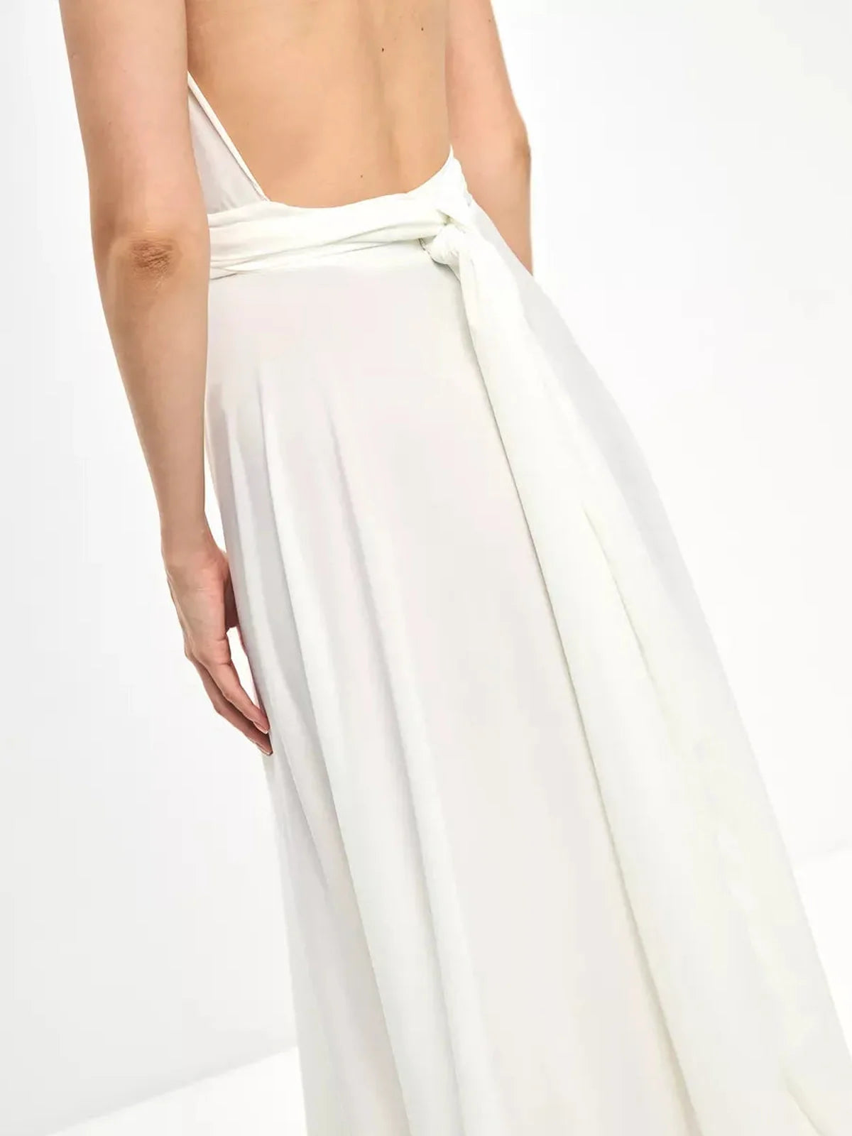 Back view of the Celeste Wrap Maxi Dress, showcasing the elegant tie detail and flowing A-line skirt.