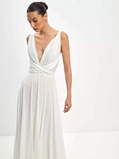 Model wearing the Celeste Wrap Maxi Dress featuring a draped V-neck and soft A-line skirt.