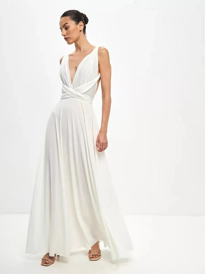 Model wearing the Celeste Wrap Maxi Dress with draped V-neck and convertible tie detail in a soft white hue.