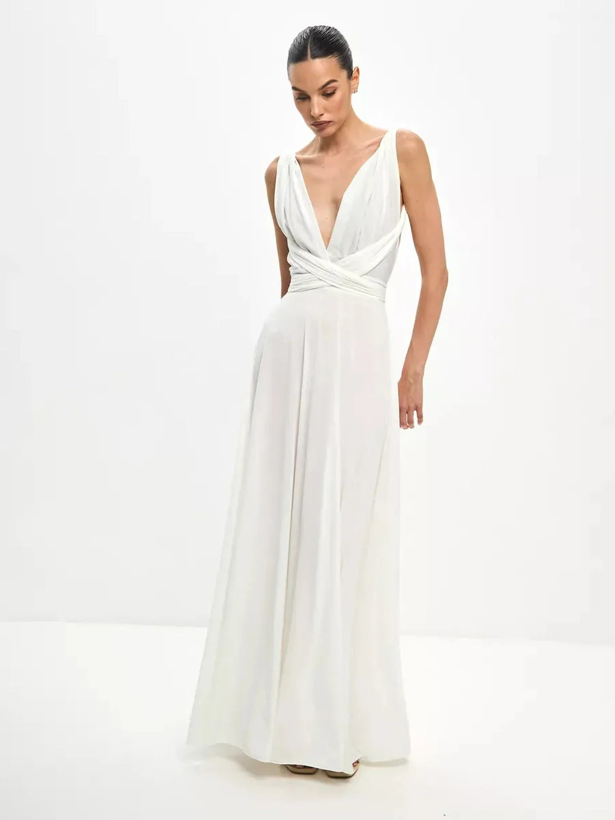 Elegant woman in a Celeste Wrap Maxi Dress with draped V-neck and convertible tie detail, showcasing a flowing A-line silhouette.