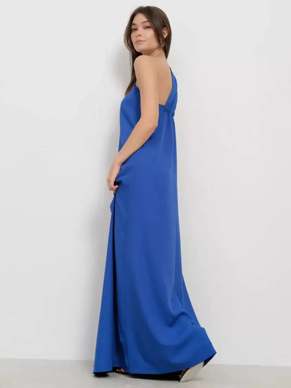 Model wearing a cerulean drape maxi dress showcasing its elegant one-shoulder design and flowing silhouette.