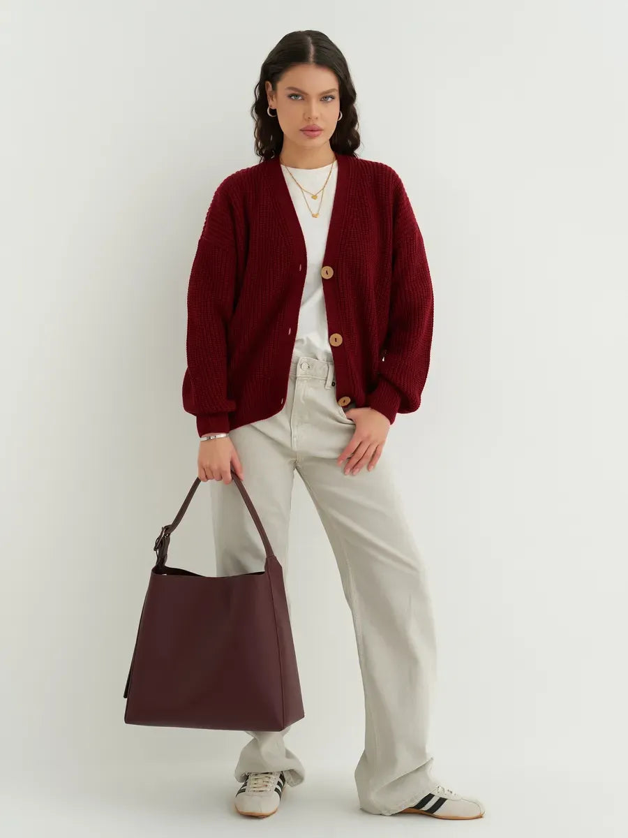 Model wearing a Cherry Cardigan by Lauven, featuring a cozy oversized design in deep cherry red.