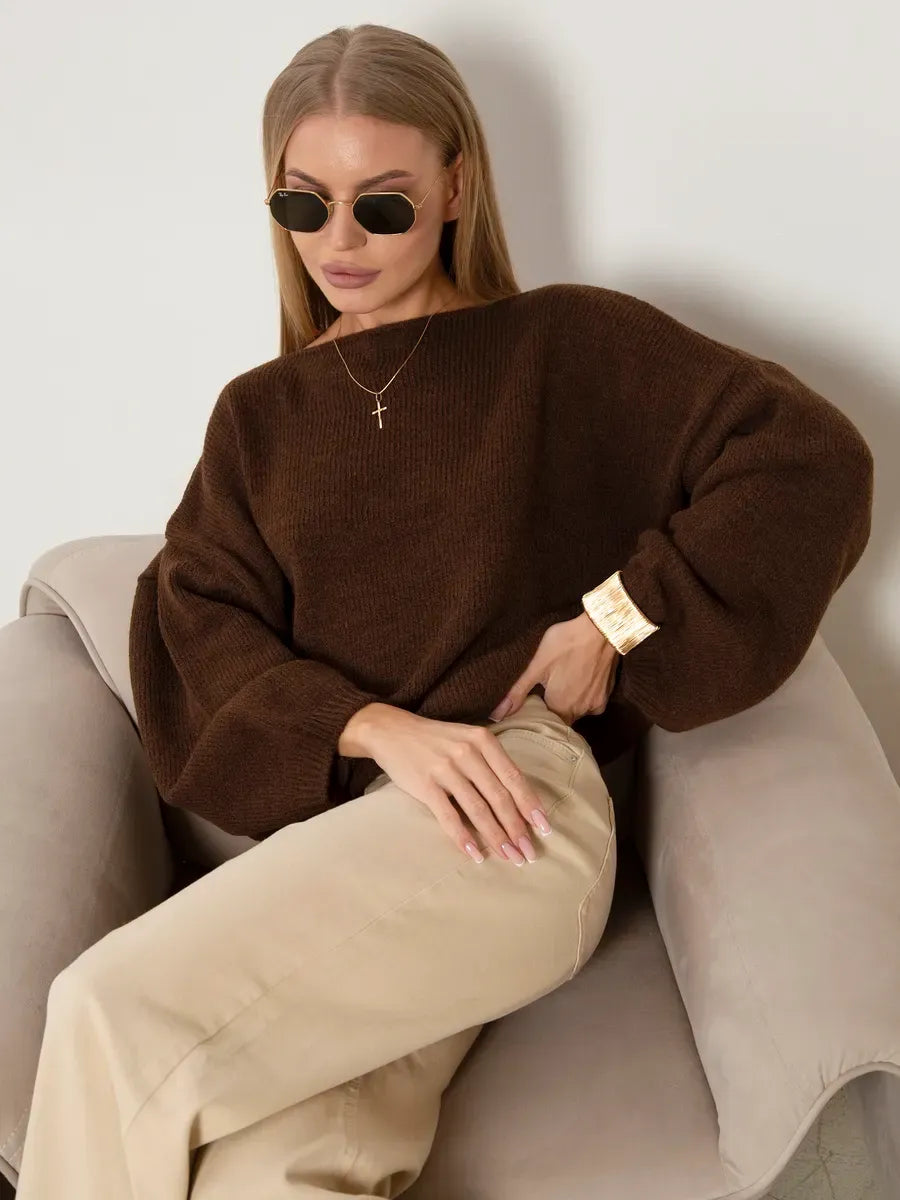 Woman wearing the Chestnut Sweater by Lauven, an oversized knit sweater with a boat neck, styled with sunglasses.
