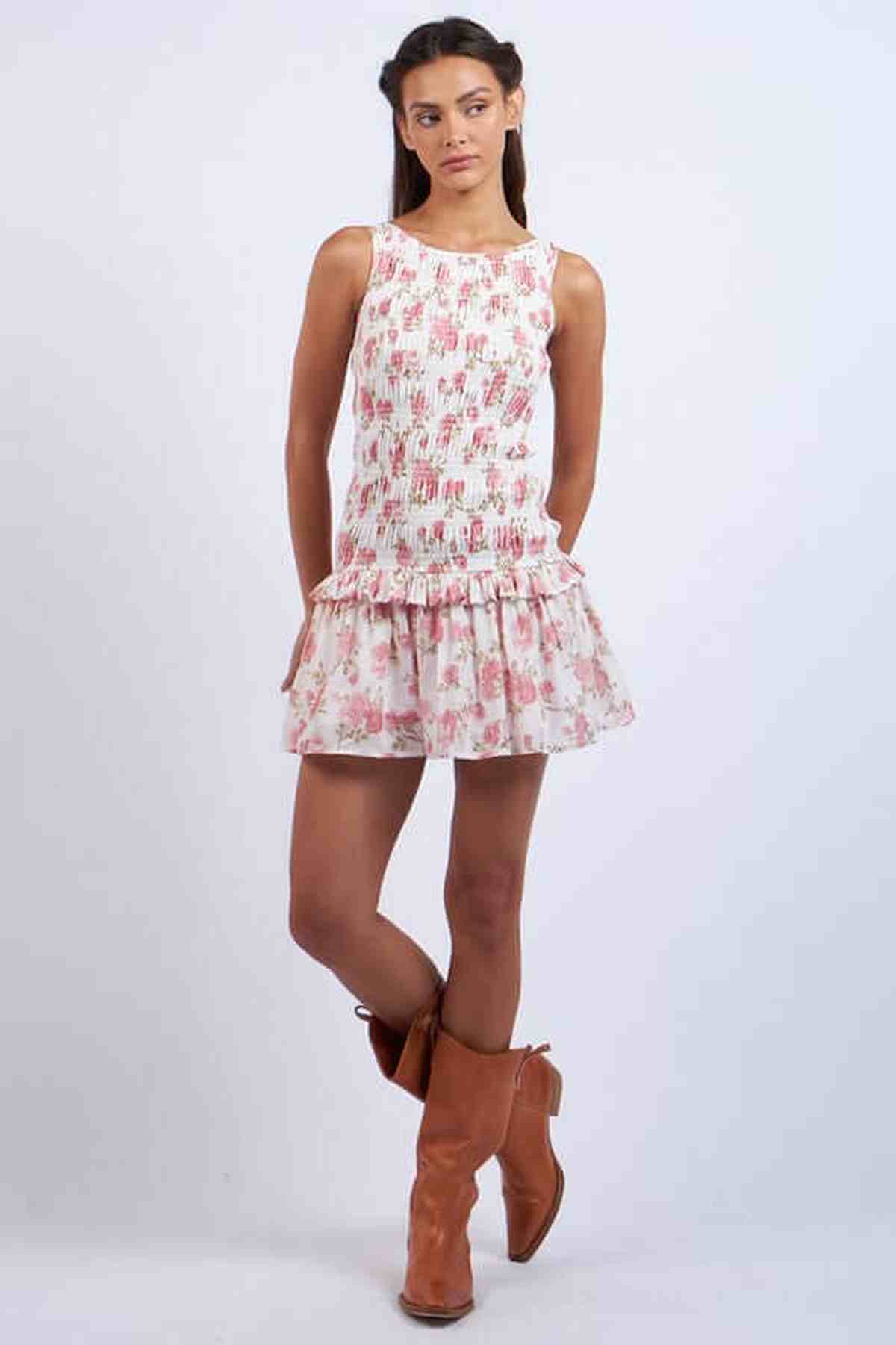 Model wearing a floral Chloe Mini Dress with tie details, perfect for summer parties or wedding guest occasions.